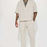 Pantalones de lino con textura sólida y cintura elástica con abertura lateral - piedra