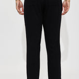 Pantalones negros de lino con textura sólida y cintura elástica lateral con abertura en los costados.