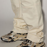 La perfección es perfeccionada con los pantalones de carga rectos y utilitarios en color blanco.