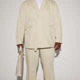 Pantalones de tela plisada de lujo Thomas - Blanco desgastado con aberturas en la parte inferior.