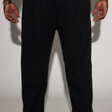 Pantalones sueltos negros con pliegues en textura Jordan