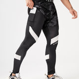 Manfinity Fitness Hombres Pantalones deportivos con estampado de slogan reflectante 2 en 1 con bolsillo para telefono