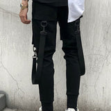 Manfinity EMRG Hombres Pantalones sueltos de carga con bolsillo de solapa, detalle de hebilla, cintura con cordon y largo largo, color negro liso, ideal para salir o musicos de rap