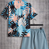 Manfinity Chillmode Conjunto De Camisa De Manga Corta Con Estampado Tropical Y Pantalones Cortos De Color Liso Para Hombre