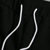 Manfinity LEGND Conjunto de dos piezas para hombre con camiseta de cuello redondo de manga corta con estampado de caricatura y pantalones cortos con cordon y bolsillo