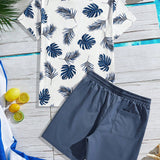 Manfinity Chillmode Conjunto de ocio para hombres de verano con estilo de vacaciones tropicales, estampado de plantas tropicales en la camiseta de cuello redondo con manga corta y pantalones cortos de cintura ajustable con cordon