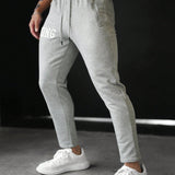 Manfinity Homme Pantalones de chandal casuales para hombre con cordon en la cintura, impresion con letras y bolsillos
