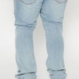 A través de los jeans desgastados ajustados con corte acampanado - lavado vintage en azul